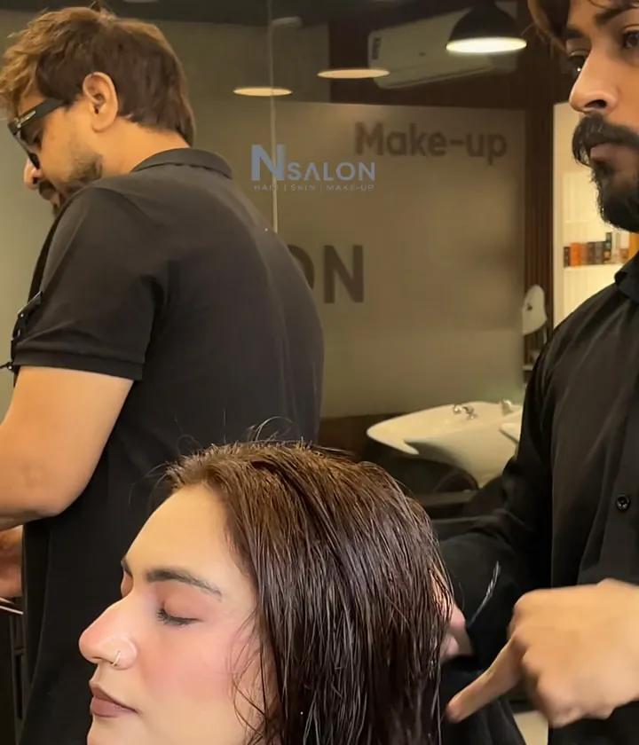 Stylist sectioning a client's hair at N Salon Pitampura