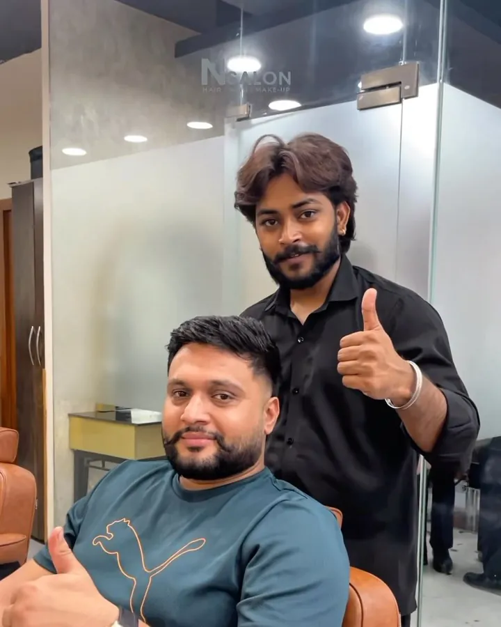 Client with a fresh fade and groomed beard, giving a thumbs-up with his N Salon Pitampura barber