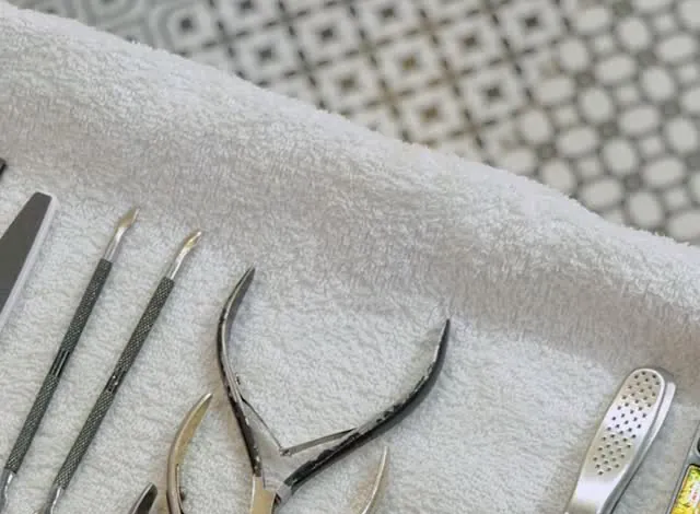 Manicure and pedicure tools laid out on a fresh towel at N Salon Pitampura
